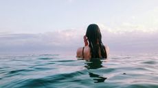 How to swim in the ocean: image shows woman swimming in the sea