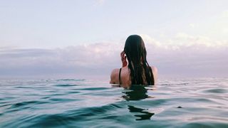 How to swim in the ocean: image shows woman swimming in the sea