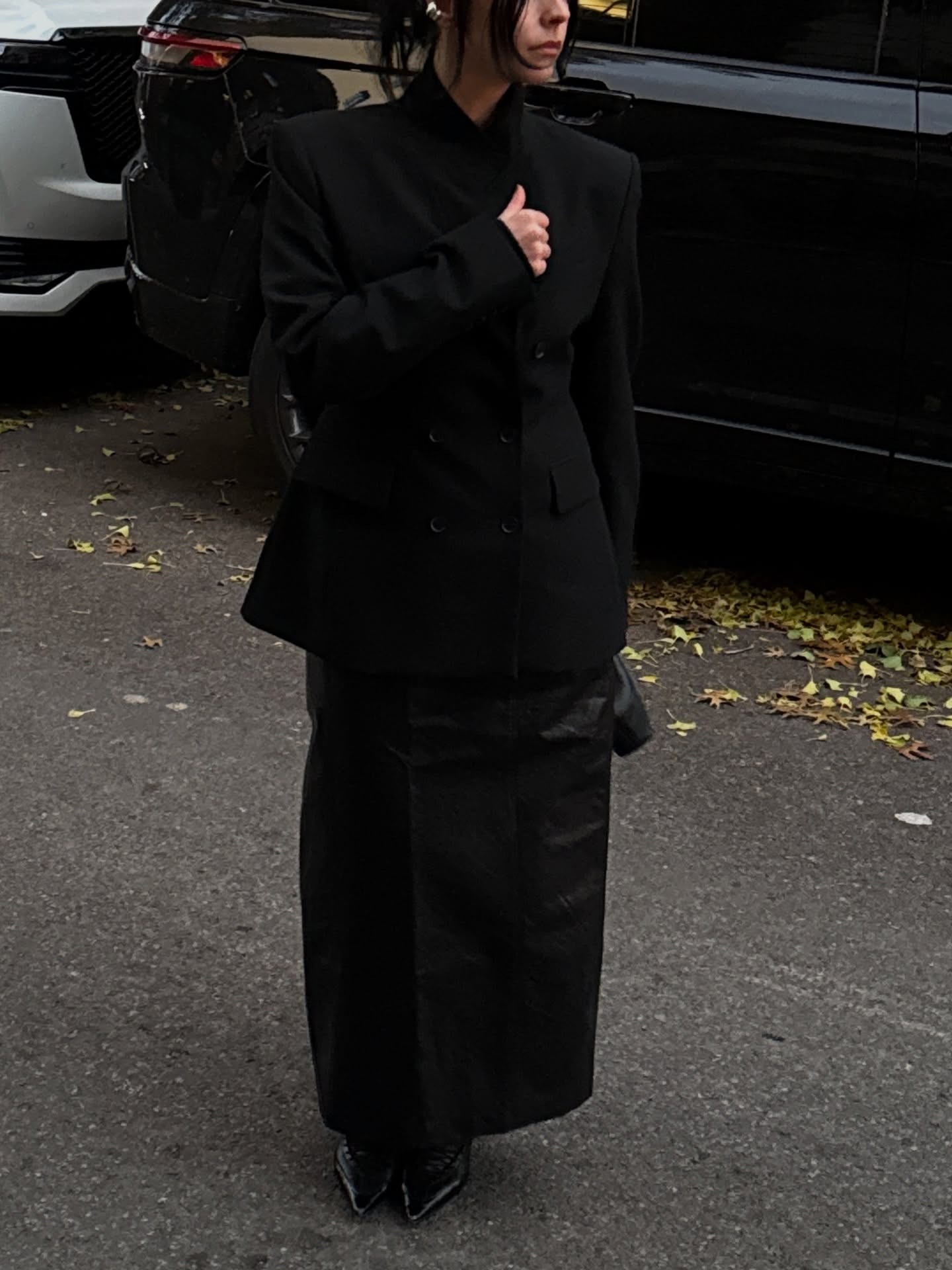 @brooklynngallagher wearing a skirt outfit idea for 2026, including a double-breasted black blazer and leather column skirt.