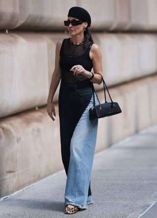 Yana Echko wearing leopard print ballet flats with jeans and a dress