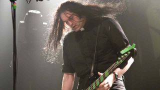 Type O Negative’s Peter Steele dressed as a vicar and playing bass onstage