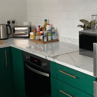 small green kitchen with marble worktops