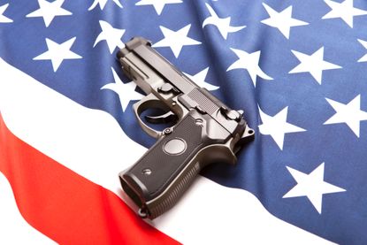 Gun on American flag.