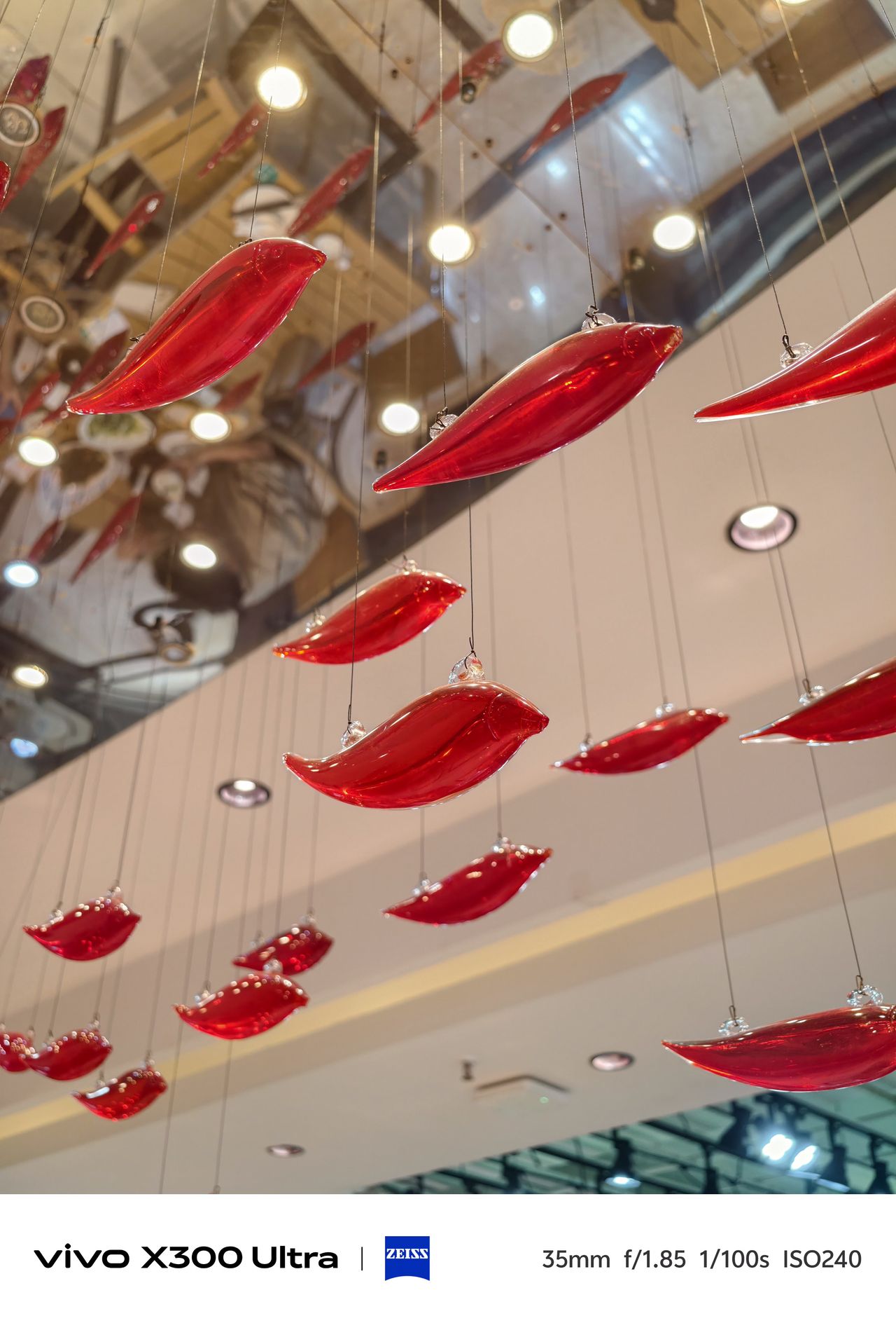 Two bright red chairs facing a table beneath a large, sculpted golden dragon on the ceiling.