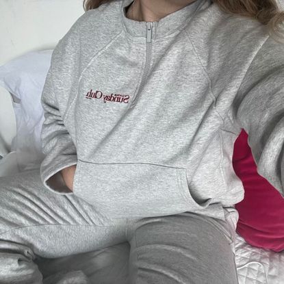 amelia wearing grey matching loungewear set with spellout on the chest