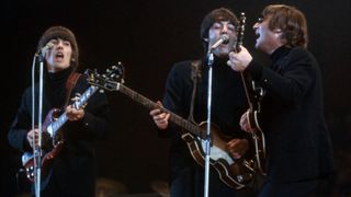 George Harrison (1943-2001), Paul McCartney and John Lennon (1940-1980) of The Beatles perform at Empire Pool in Wembley at the New Musical Express Annual Poll Winner's Concert in what would be their final scheduled performance in England, on May 1, 1966, in London, UK.