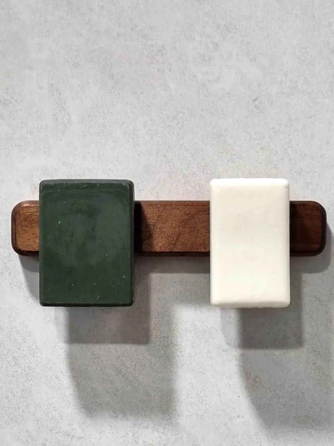 A wooden soap holder with a magnetic back
