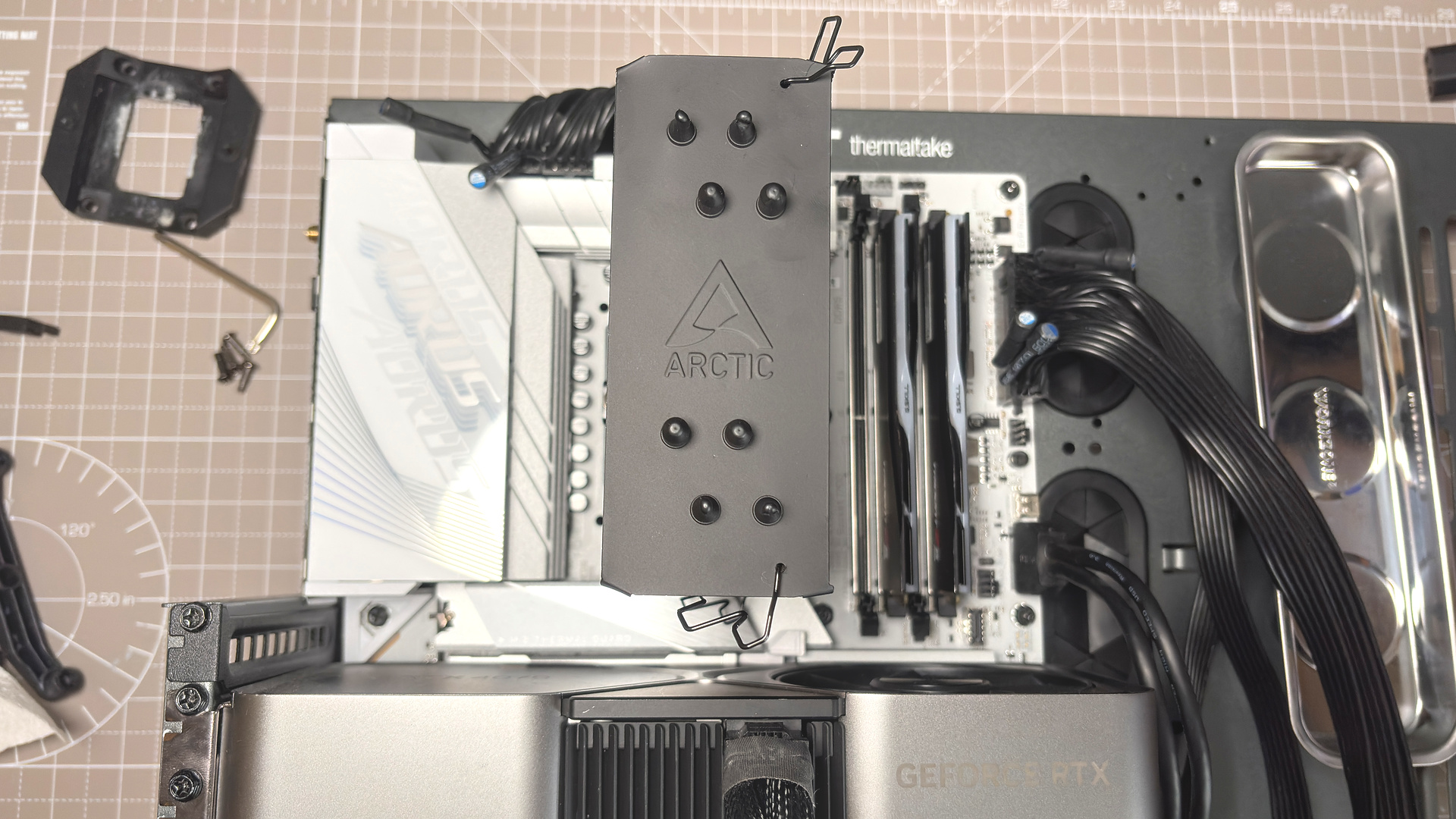 An Arctic Freezer 36-S on a desk and installed in a gaming PC, with the Freezer 36 nearby.