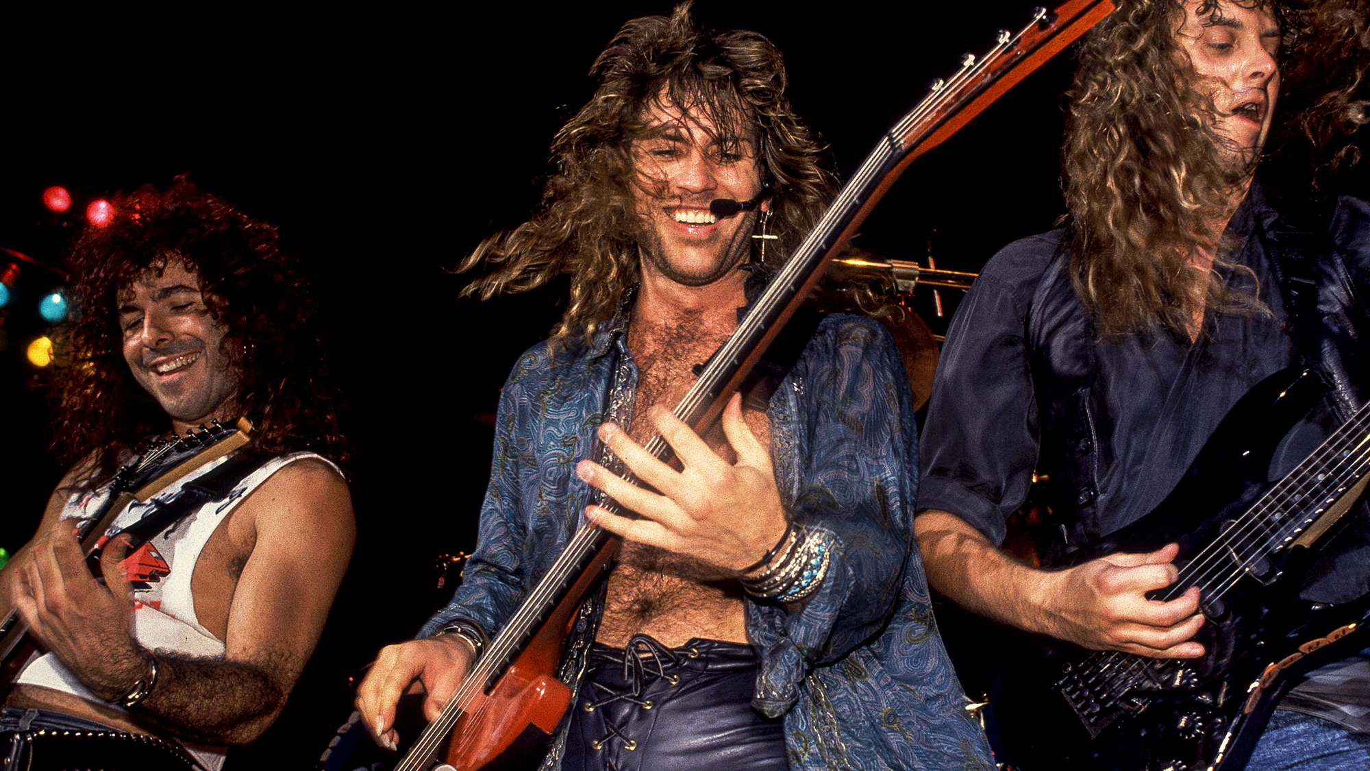 American Rock musicians Paul Taylor, Kip Winger, and Reb Beach, all of the group Winger, perform onstage at the Poplar Creek Music Theater, Hoffman Estates, Illinois, July 27, 1989.
