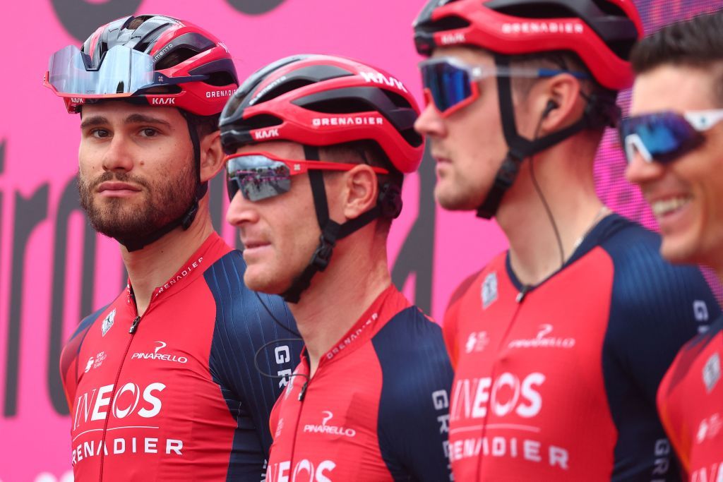 INEOS Grenadierss Italian rider Filippo Ganna L and teammates stand on the podium during the teams presentation prior to the seventh stage of the Giro dItalia 2023 cycling race 218 km between Capua and Gran Sasso dItalia on May 12 2023 Photo by Luca Bettini AFP Photo by LUCA BETTINIAFP via Getty Images