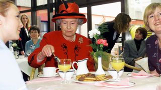 Queen Elizabeth II takes a tea break with hospital staff during her visit to Manchester Royal Infirmary