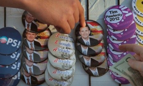 A Tim Pawlenty supporter buys a button in Ames, Iowa