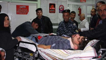 An injured man receives treatment in hospital following deadly earthquake