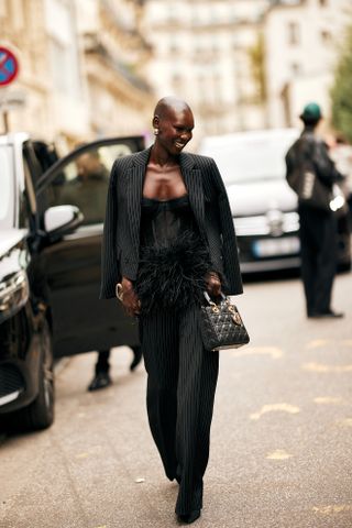 woman wearing blazer, top, and tailored trousers