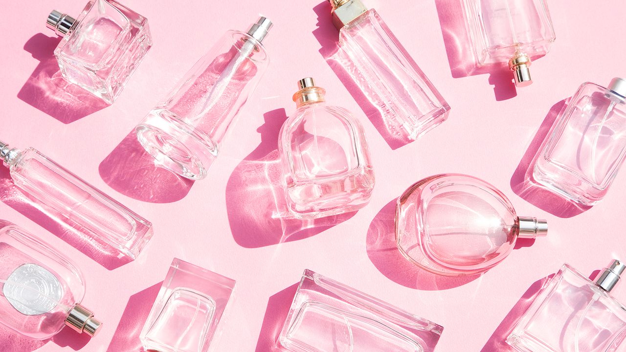 flatlay of perfume bottles on pink background