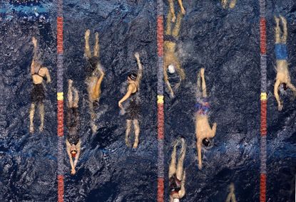 Swimmers warm-up during the U.S. Winter Nationals swimming event in Federal Way, Wash.