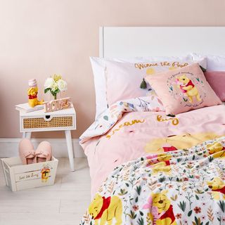 bed with winnie the pooh and blanket