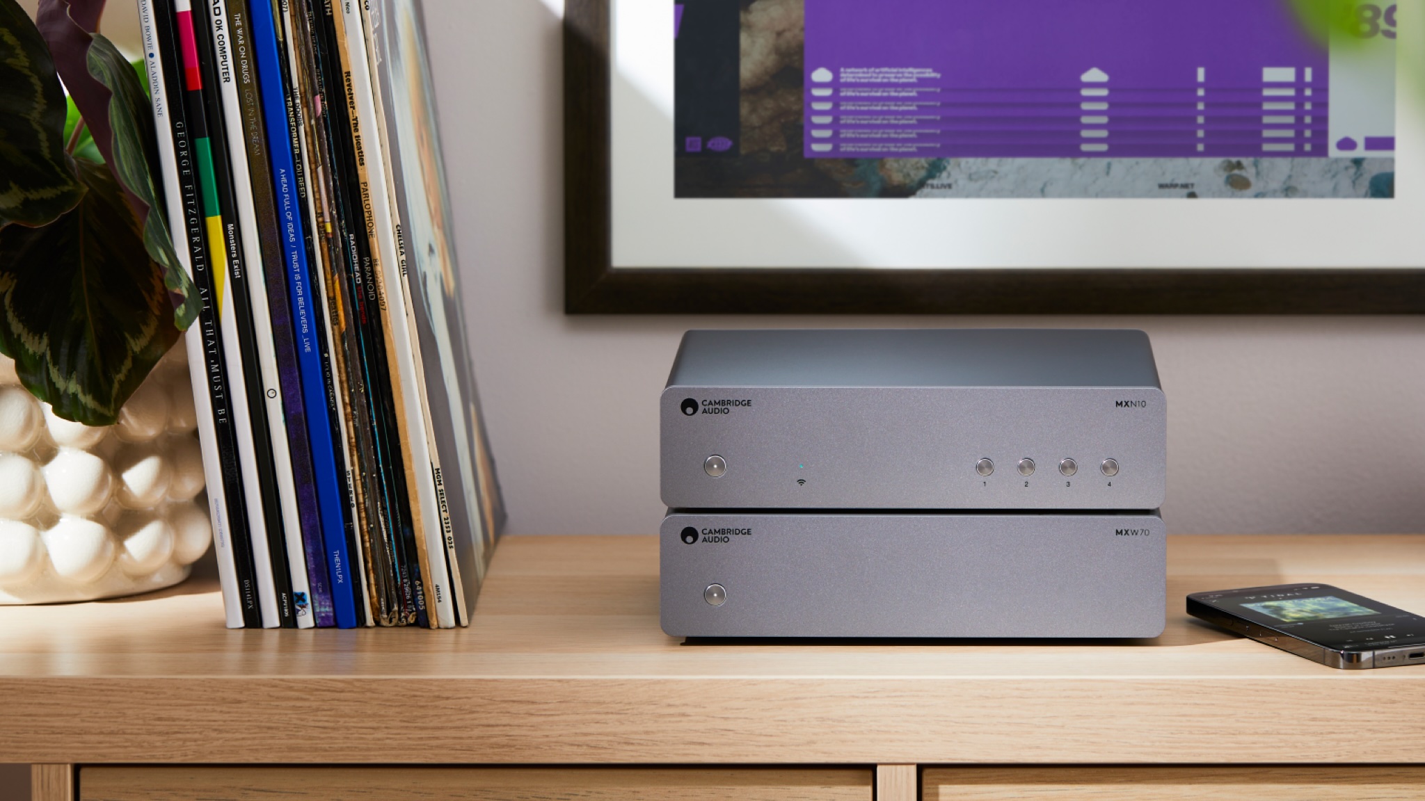 Cambridge Audio MXW70 amplifier and MXN10 streamer stacked up on a wooden sideboard in a brightly lit room