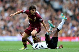 David Silva of Manchester City goes past the challenge from Hugo Rodallega of Fulham during the Barclays Premier League match between Fulham and Manchester City at Craven Cottage on September 29, 2012 in London, England.