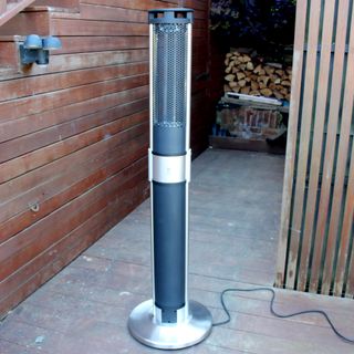 The Swan patio heater in a decked outdoor space
