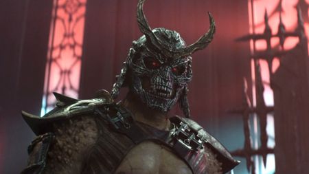 Shao Khan looking down at Kitana. 