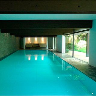 swimming pool with black ceiling and blue wall