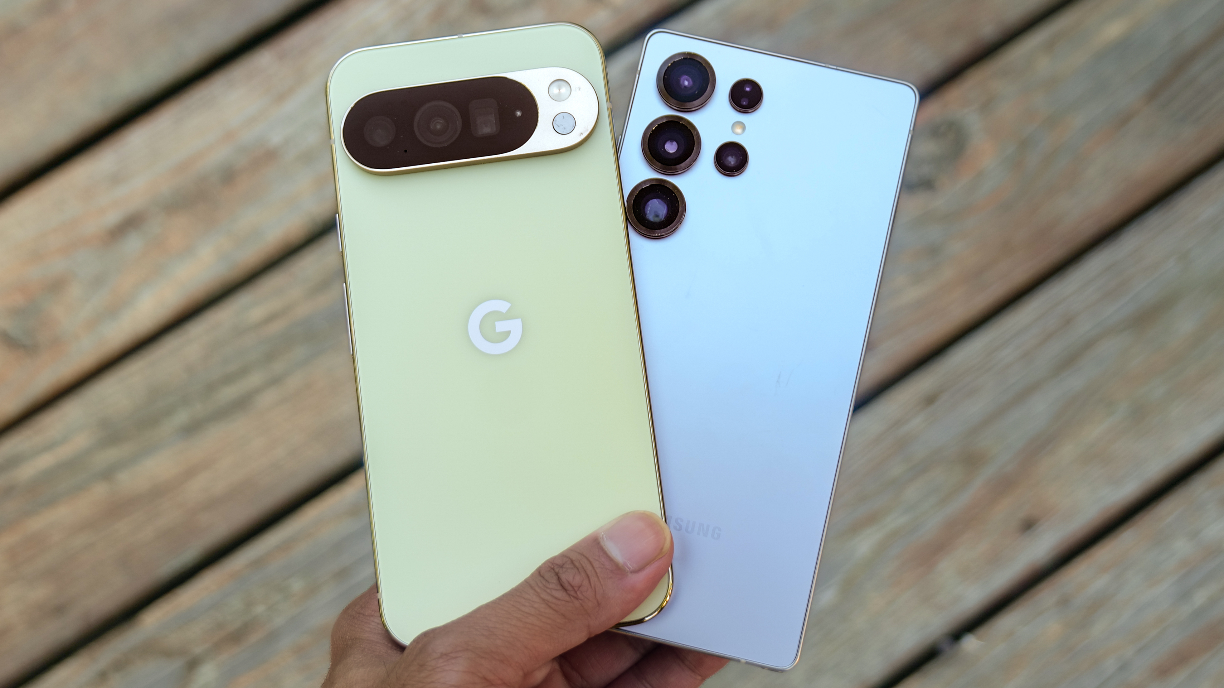 Pixel 10 Pro XL vs Galaxy S25 Ultra held in the hand.