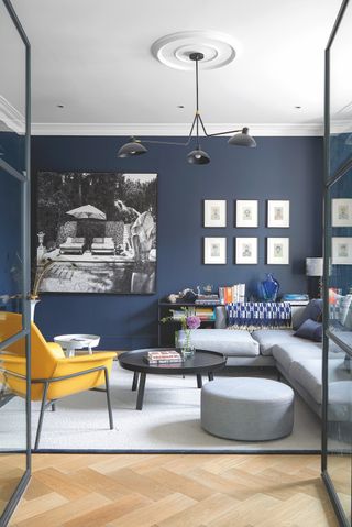 blue living room with pale grey corner sofa