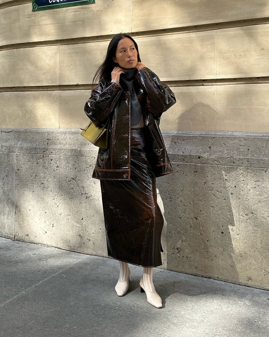 @vikilefevre wears a leather midi skirt