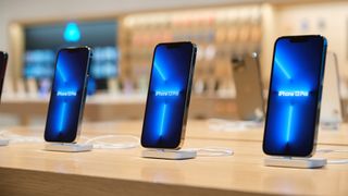 iPhone 13 Pro models on display in an Apple Store