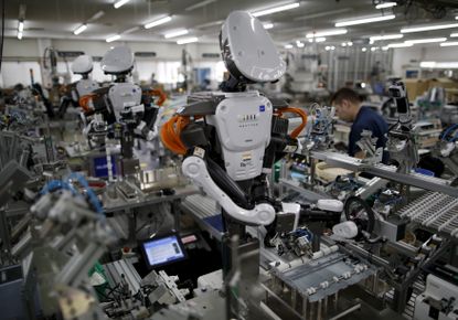 Robots working on the assembly line at a factory in Tokyo.
