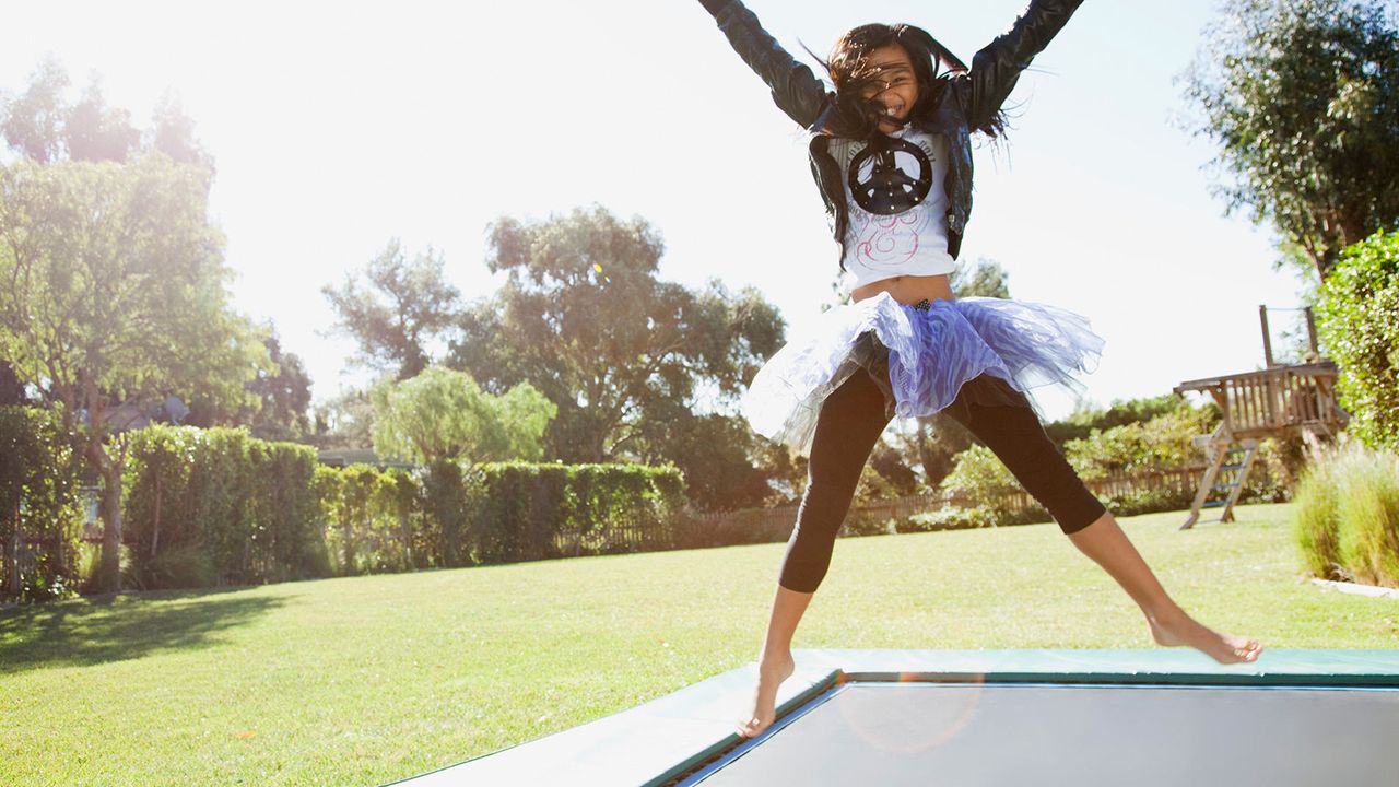 girl bouncing on a trampoline