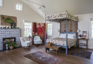 Four poster bed blue tiled fireplace