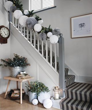 hallway with garland and oversized white paper decorations