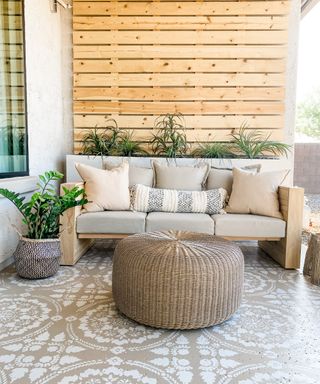 A DIY outdoor sofa with selection of neutral outdoor cushion decor on decorative patio floor
