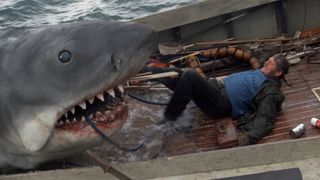 The shark attempts to eat a fisherman in Jaws