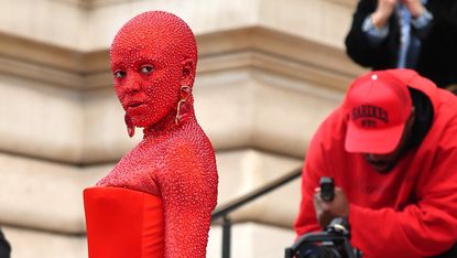 oja cat in a red dress covered in 30,000 swarovski crystals