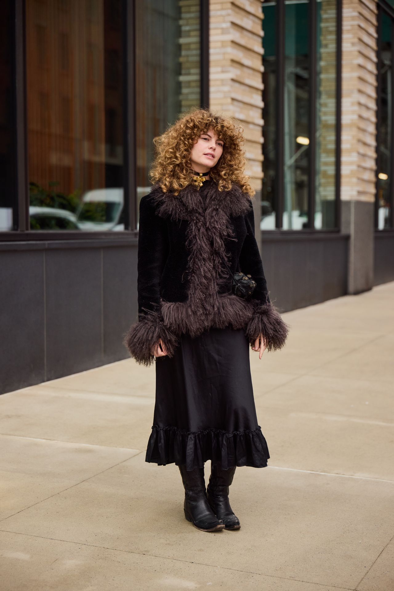 Lauren Valenti wearing a fur trim coat and black skirt during F/W 25 fashion week in New York.