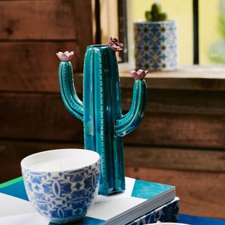 cactus ring holder with tea cup on book