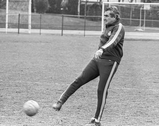 Real Madrid coach Miguel Muñoz kicks a ball during a training session in 1973.
