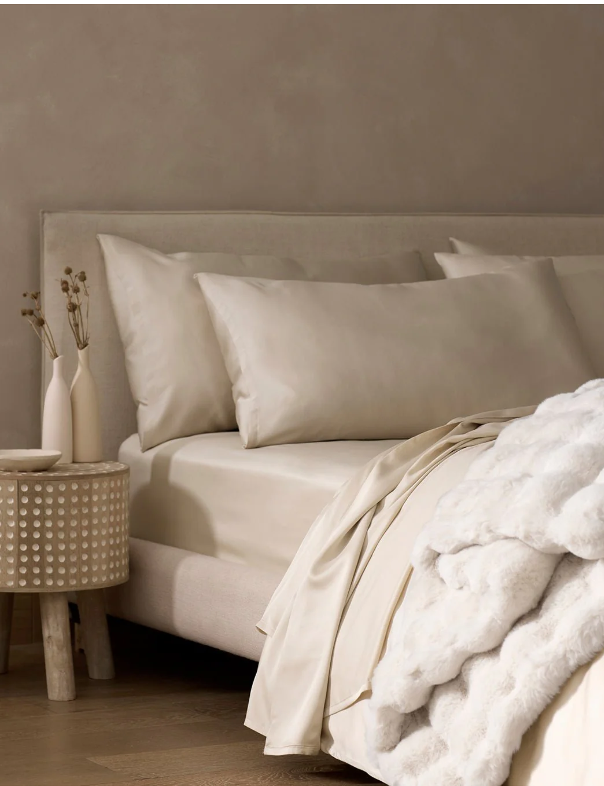 Neutral bedroom featuring a sleek-lined modern bed frame and neutral bedding