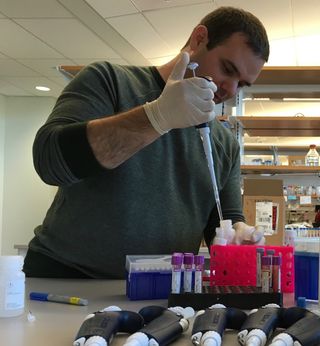 Darwin’s Dogs team member Jesse McClure extracts DNA from a sample.