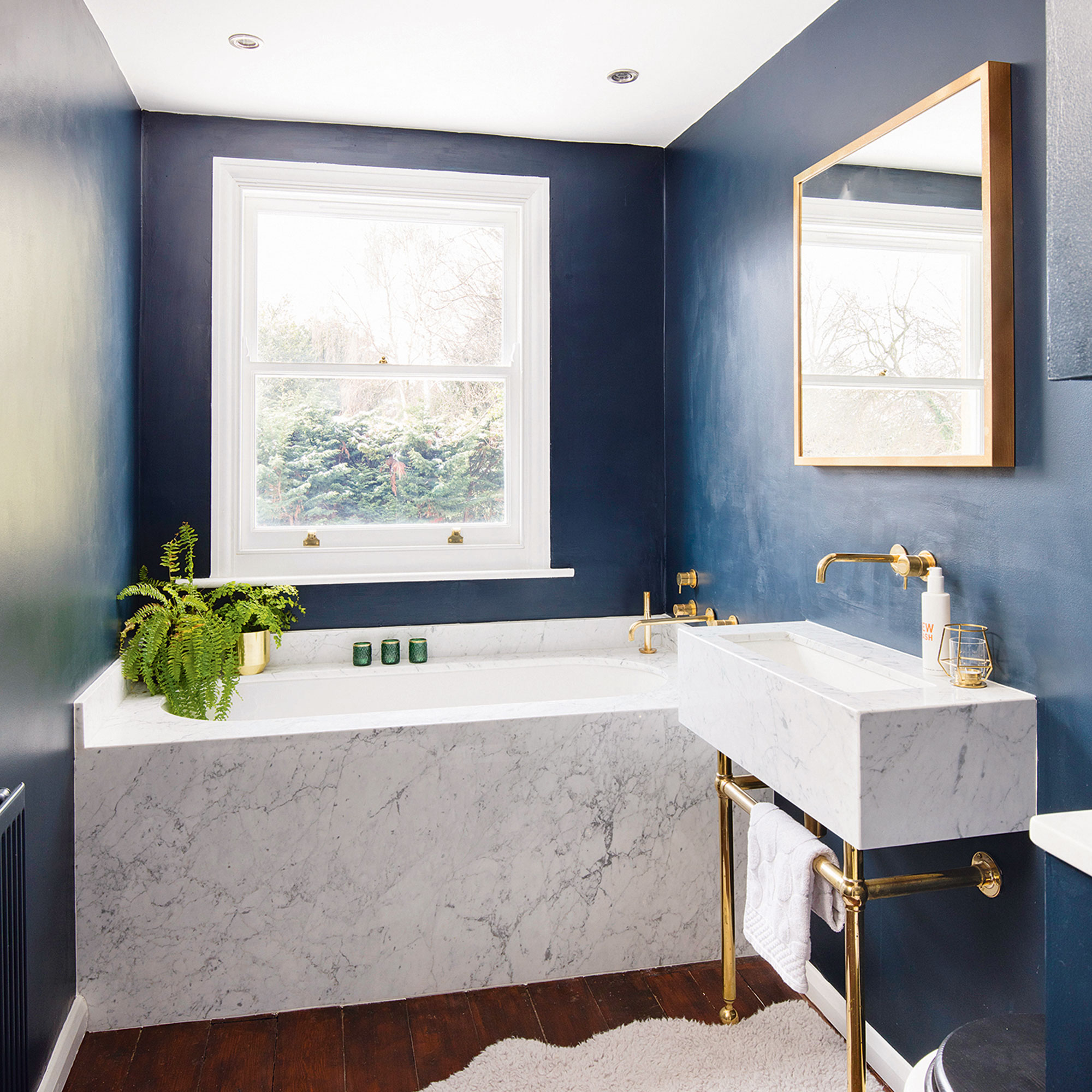 Blue bathroom with marble tub and marble sink