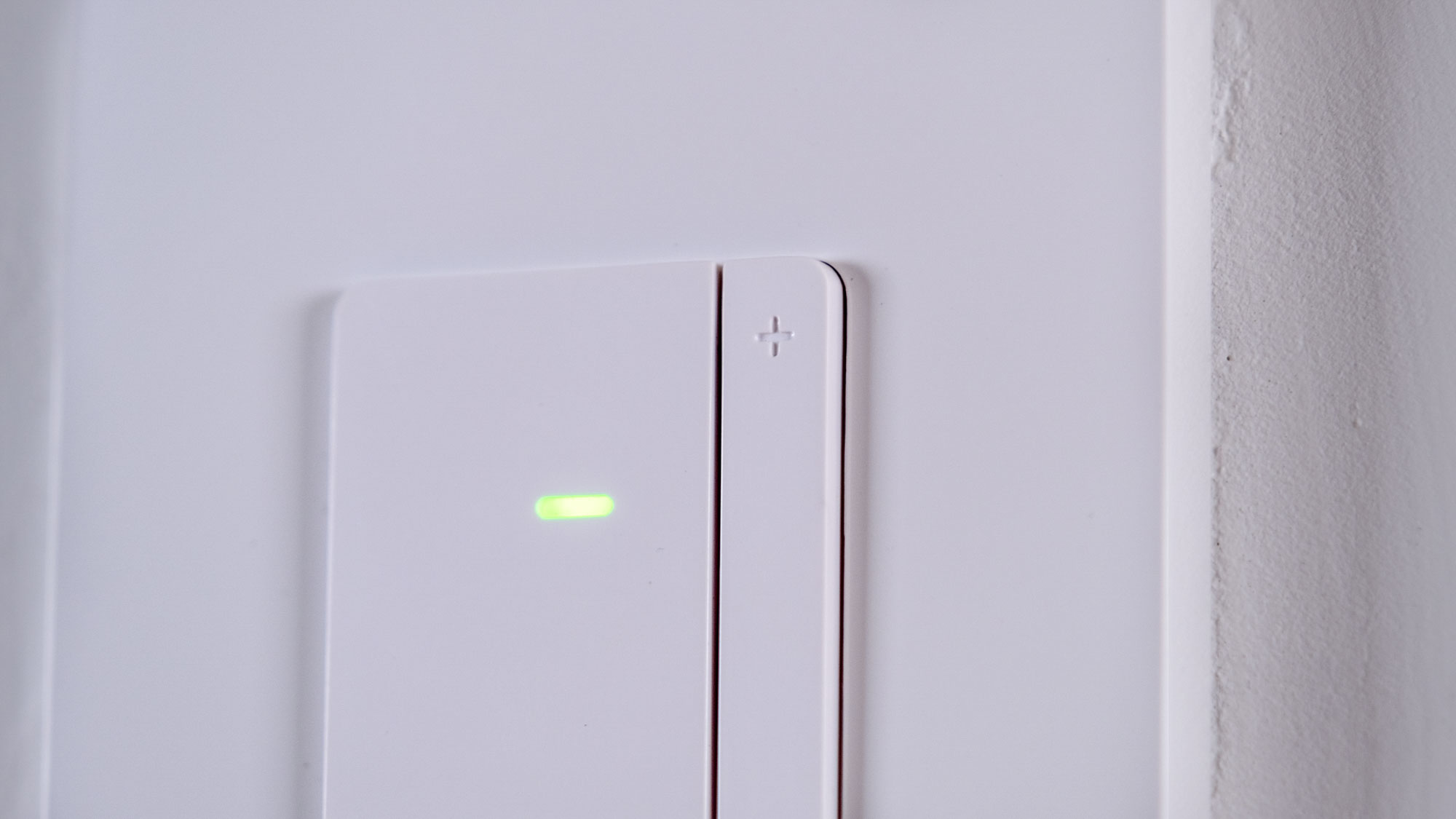 The Eve Dimmer Switch mounted on a white wall
