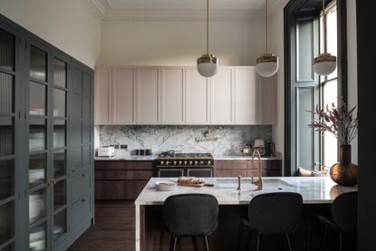 a grey kitchen with off-white walls