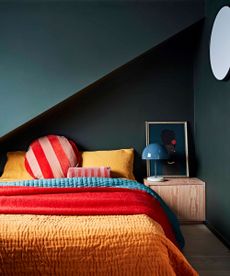 bedroom tv ideas dark green bedroom with colourful bedlinen 