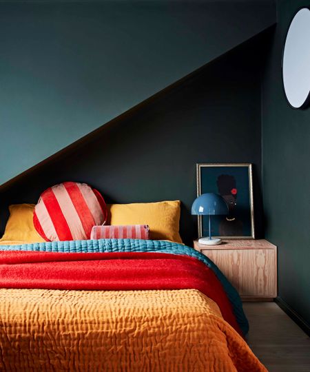 bedroom tv ideas dark green bedroom with colourful bedlinen 