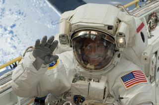 Astronaut Danny Olivas waves while on a spacewalk during the STS-128 shuttle mission to the International Space Station in September 2009.