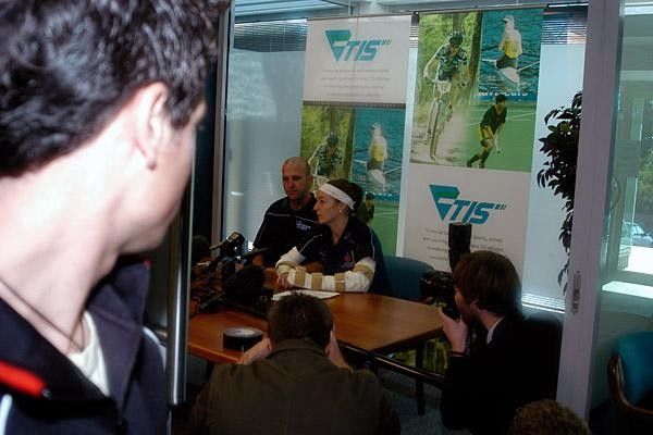 Louise holds her media conference watched by boyfriend Mark Padget