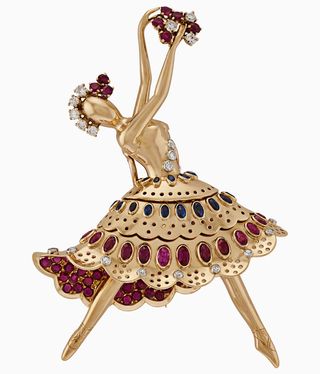 Ballerina in gold with colourful stones on her skirt